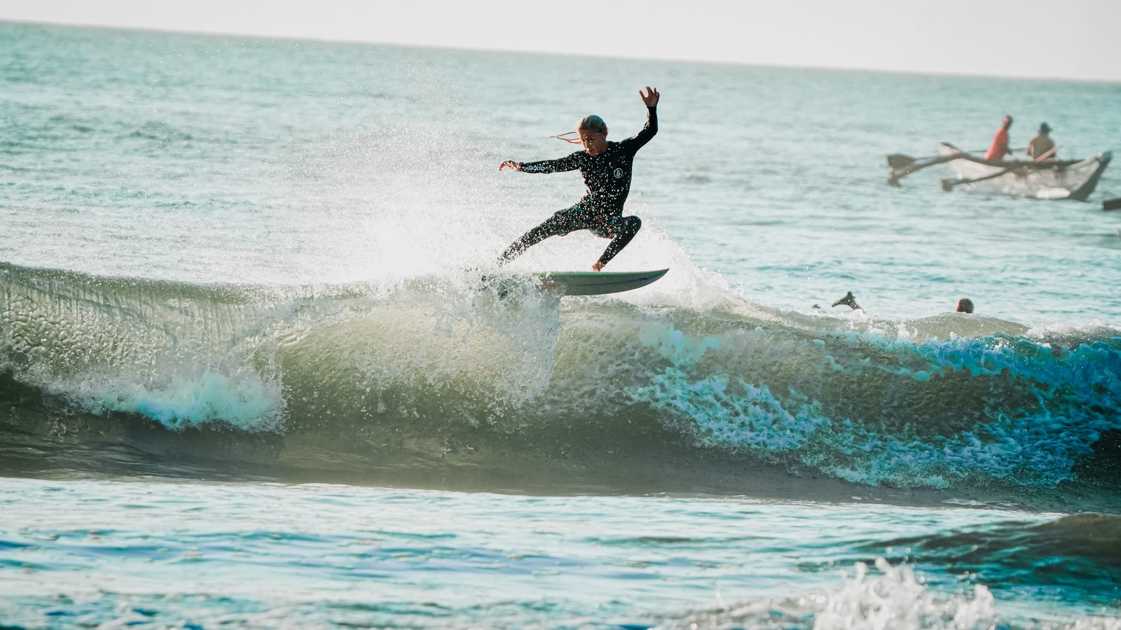 Surfer mid-cutback at dawn